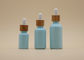 Colorez les bouteilles d'huile essentielle du bleu de ciel de revêtement 15ml 30ml avec le compte-gouttes en bambou