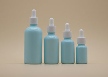 Le compte-gouttes bleu d'huile essentielle de revêtement met la bouteille en bouteille en céramique blanche pour le soin personnel
