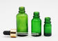 Bouteilles de compte-gouttes d'huile essentielle de couleur verte de soins de la peau avec le compte-gouttes en aluminium